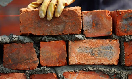 Labourer lays bricks