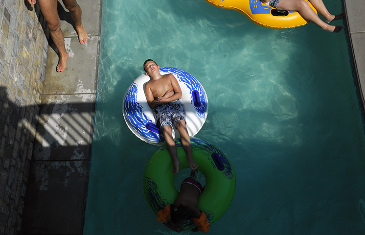 24hours in pictures: Childrens relax in a swimming pool in Kosovo