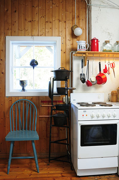 Homes: Norwegian House: The kitchen showing the oven and traditional blue painted chair