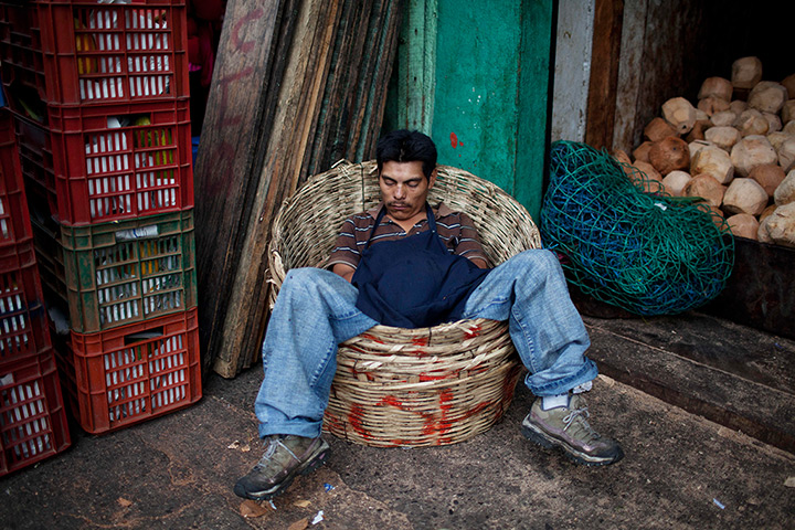 24 hours in pictures: A coconut seller naps in La Terminal market, Guatemala City