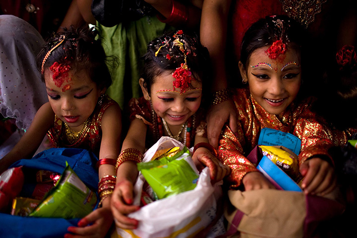 24 hours in pictures: Nepalese girls wearing a traditional attire receive gifts