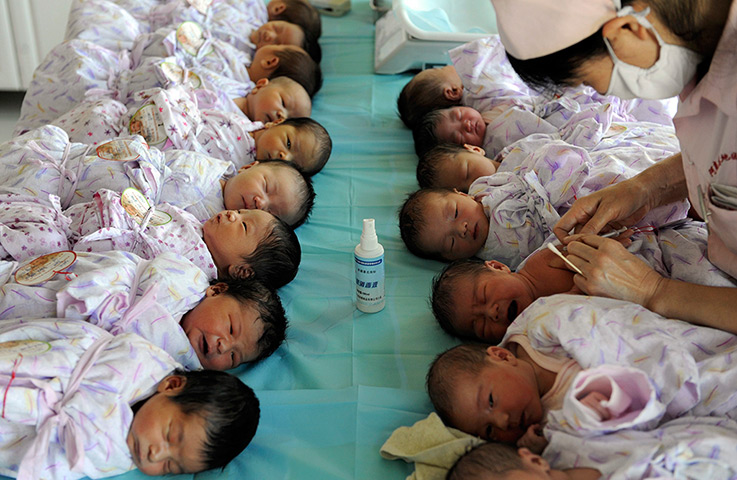 24 hours in pictures: Newly born babies receive vaccines at a hospital 