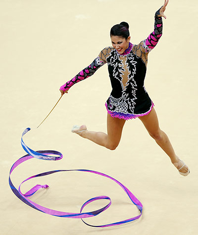 floor gymnastics: Carolina Rodriguez from Spain leaps over her ribbon