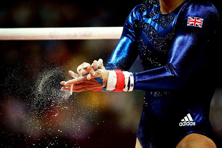 graeme best pics: A member of the British gymnastics team chalks her hands before her routine