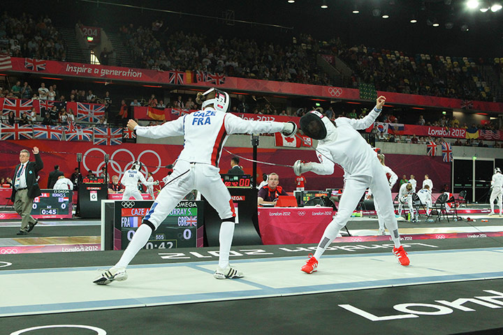 Modern Pentathlon Oly: Amelie Caze, left, of France fences with Samantha Murray of Team GB