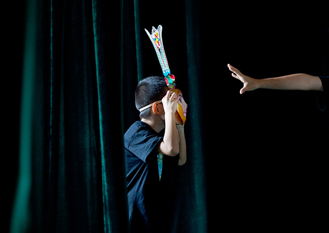 24 hours in pictures: A child wearing a monkey mask performs Chinese traditional Peking Opera