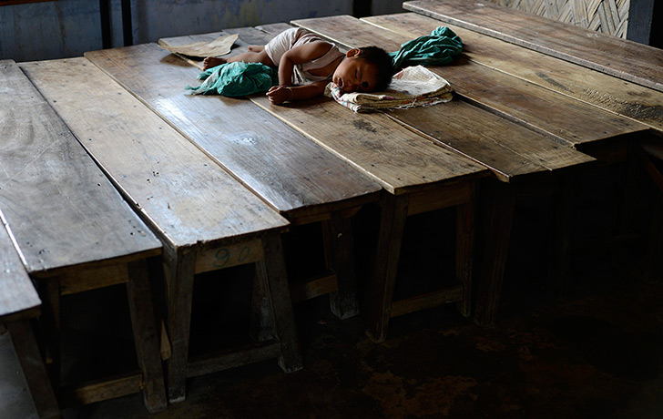 24 hours in pictures: A little girl takes a nap at Deborgaon relief camp 