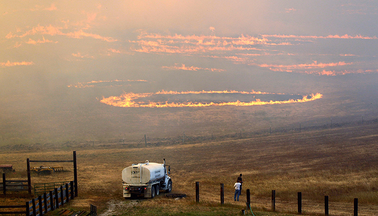 24 hours in pictures: People watch wildfire roar across ranch land in Cle Elum, Washington