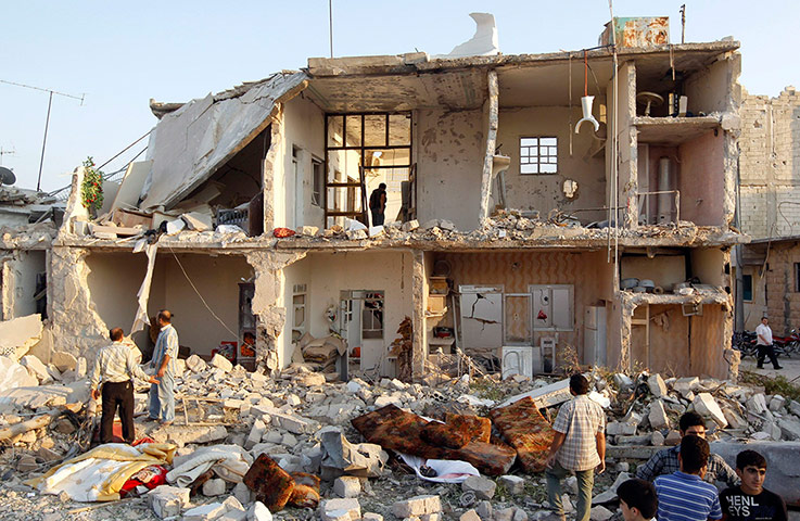 Syrian Conflict: Syrian Conflict: A man searches among houses in Azaz
