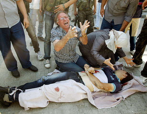 Syrian Conflict: A man and woman cry over the body of their son in Aleppo