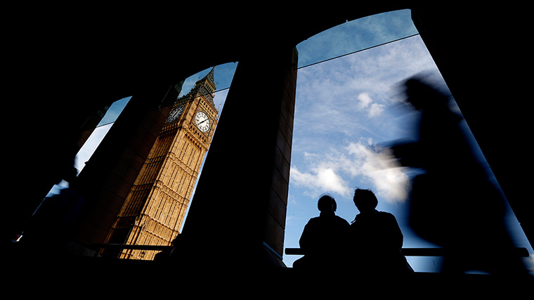 24 hours in pictures: eople are silhouetted under a building across the street from Big Ben