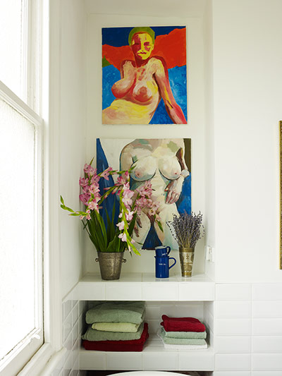 Homes: Bathroom: Paintings and flowers decorating a bathroom