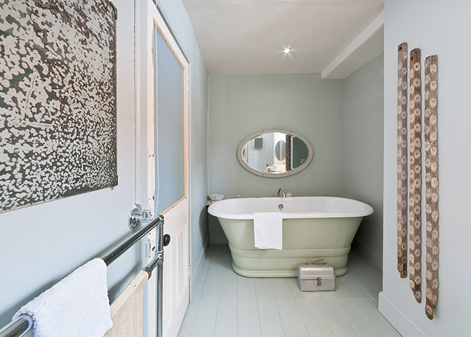 Homes: Bathroom: Muted pastel colours in a bathrrom with a roll top bath