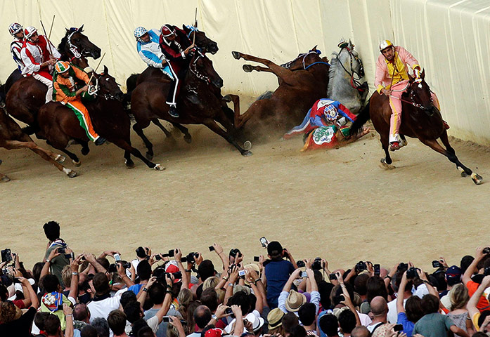 Il Palio: Riders fall as their horses crash during the Palio race in Siena
