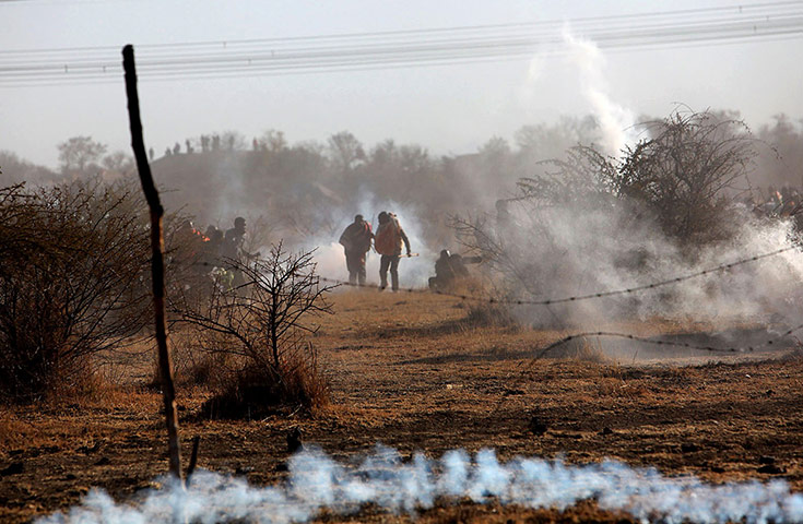 24 hours in pictures: Rustenburg, South Africa: striking miners are caught in teargas