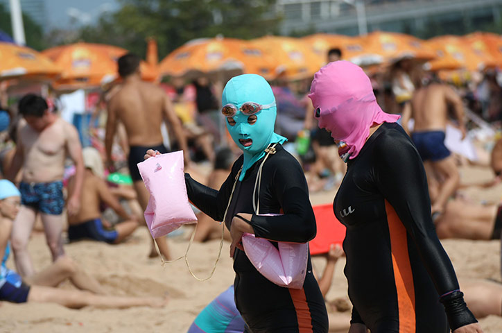 24 hours in pictures: Women wear face masks and full body wetsuits 