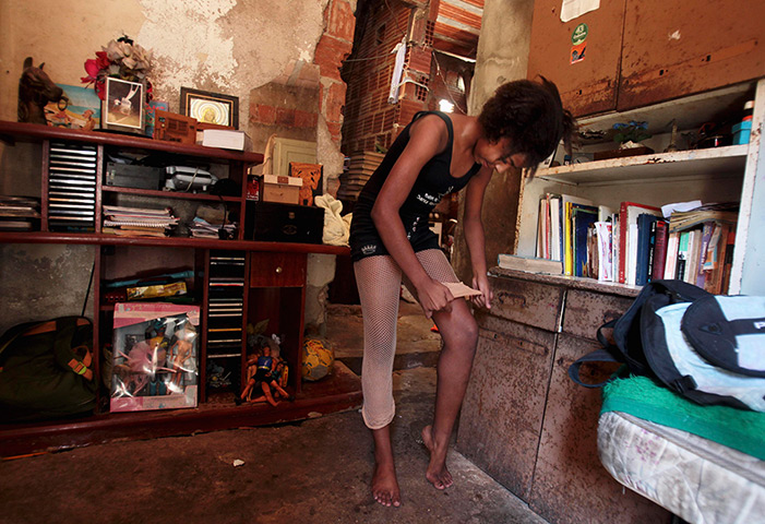 From the agencies: Marie Ellen da Silva adjusts her stockings in her home