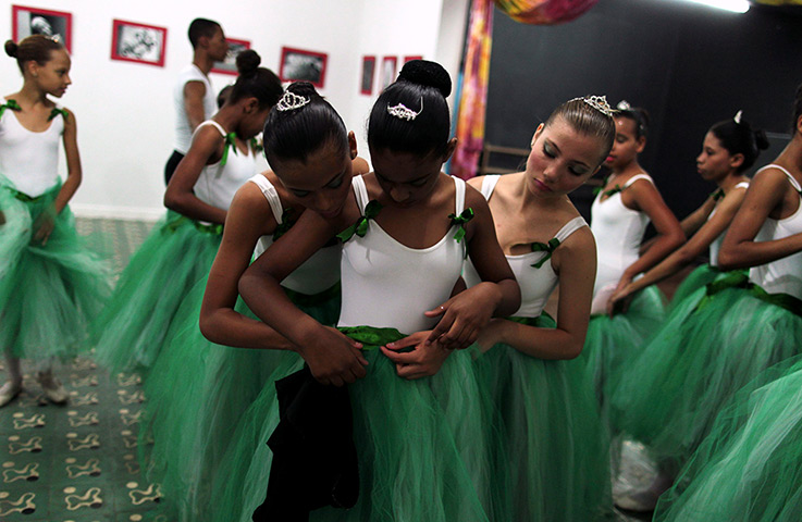 From the agencies: Girls fit their ballet skirts during their ballet class