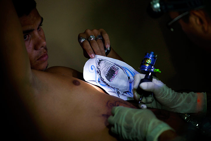 24 Hours:  A man has an image of a shark tattooed on his stomach in Havana