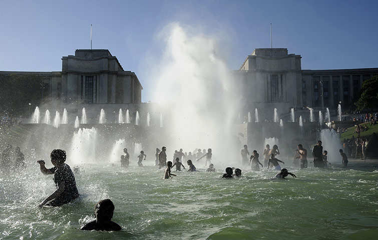 24 Hours: People cool off in the Trocadero's fountain in Paris