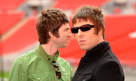 Noel and Liam Gallagher look past each other in an empty arena