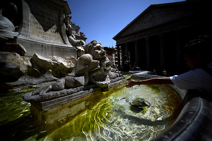 24 hours: Rome, Italy: Tourists cool off in a fountain during a heatwave