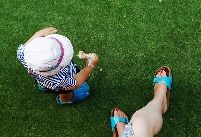 24 hours: London, England: A child eats an ice cream with his mother in the heat