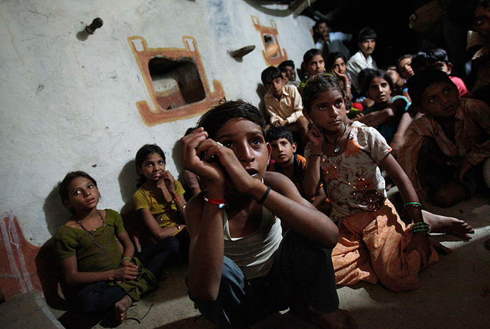 24 hours: Meerwada, India: Children watch television powered by solar energy
