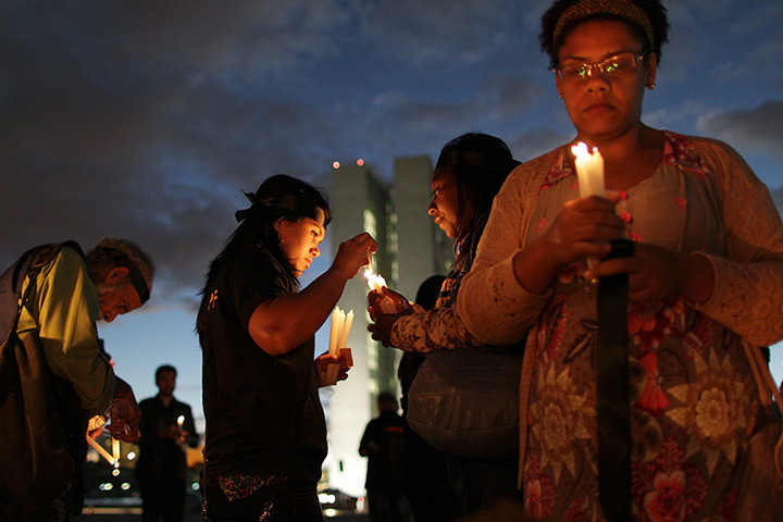 24 hours: Brasilia, Brazil: Federal police officers light candles during a protest