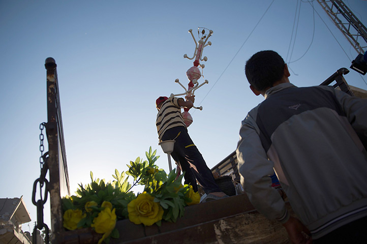 24 hours: Azaz, Syria: A boy loads some belongings into a truck after a bombing