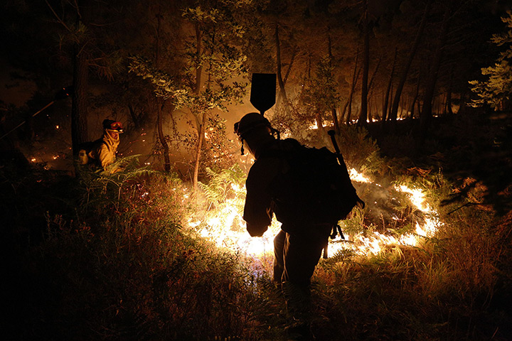 24 hours in pictures: Firefighters work at the site of a wildfire in Tabuyo del Monte