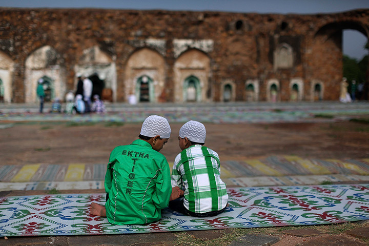 24 hours in pictures: Muslim boys sit at the ruins of the Feroz Shah Kotla mosque