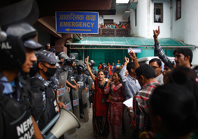 24 hours: Kathmandu, Nepal: Relatives and supporters of Tara Sharma Phuyal, who died giving birth, protest outside the maternity hospital