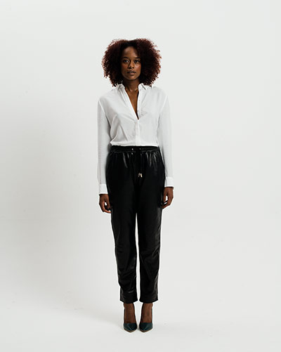 All Ages Fashion: Leather: Woman in white shirt and black leather trousers