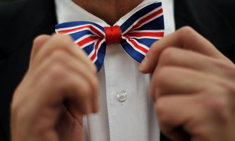 Man adjusts union jack bow tie