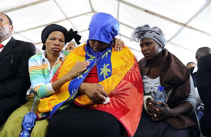 24 hours: Marikana, South Africa: A woman is comforted during a memorial service