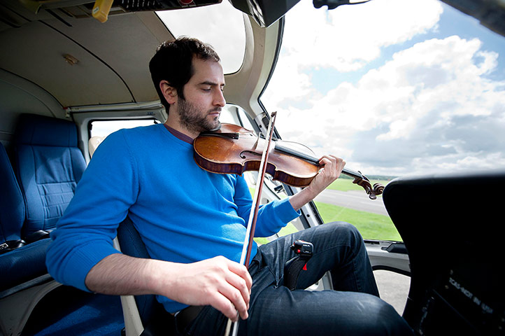Mittwoch aus Licht: A man sits in a helicopter playing the viola