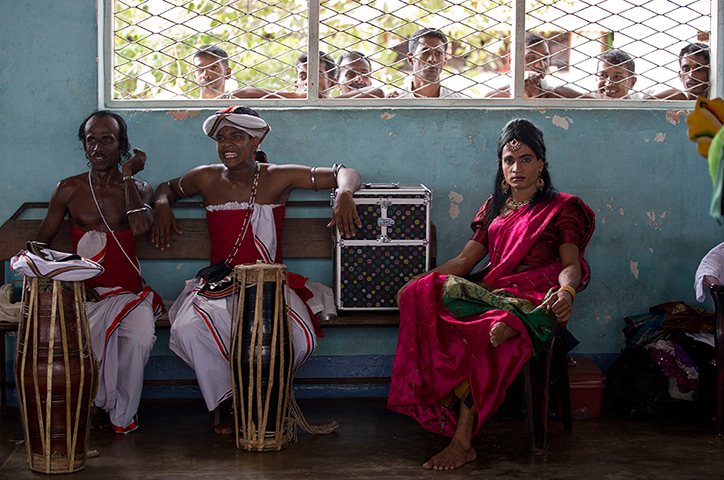 24 hours in pictures: Prisoners peep through a window at fellow prisoners dressed as a woman
