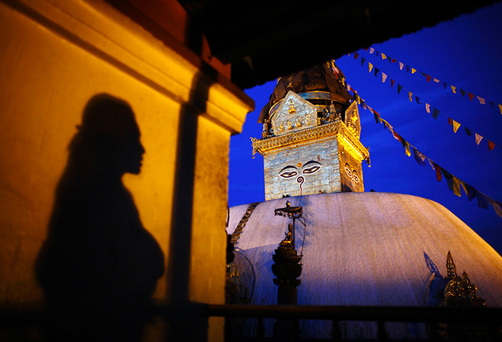 24 hours in pictures: Shadow of a woman is cast on the wall of a monastery, Nepal