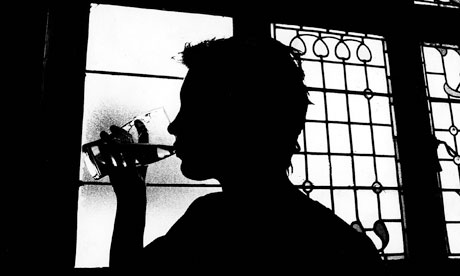 A man drinking in a pub