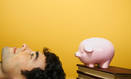 Young man next to piggy bank