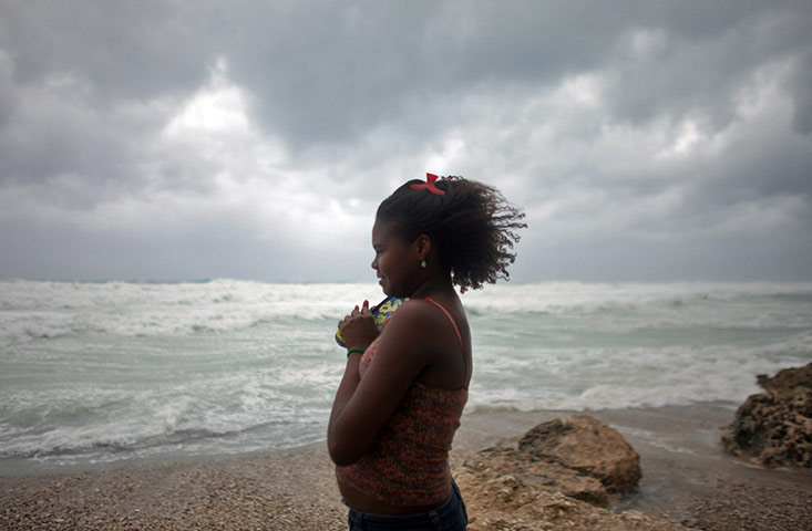 Tropical storm Isaac: A woman looks out at the sea as Tropical Storm Isaac approaches Barahona