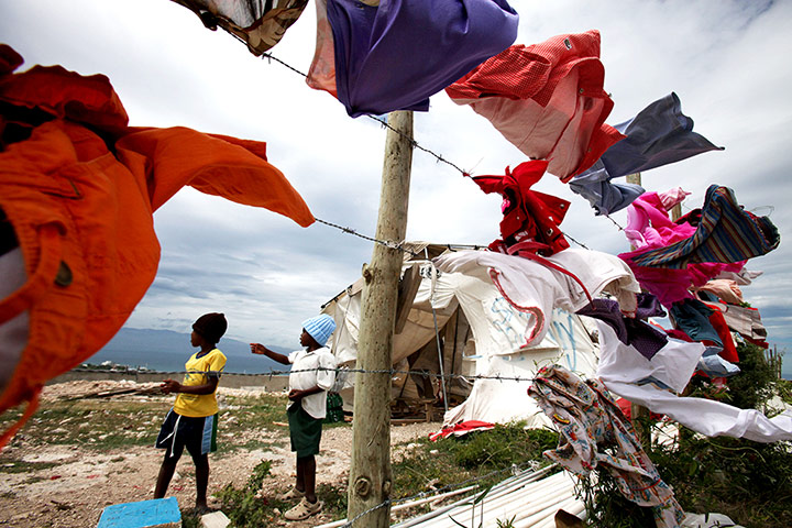 Tropical storm Isaac: Children watch as clouds from Tropical Storm Isaac move over Port-au-Prince