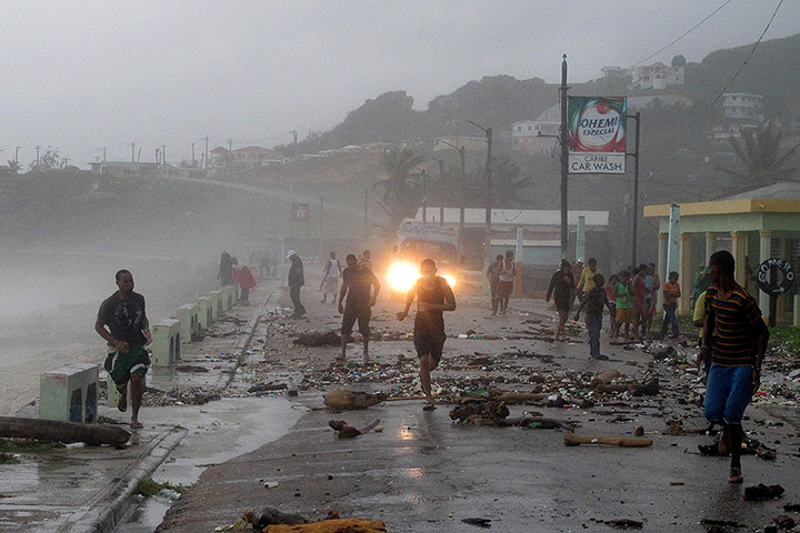 Tropical storm Isaac: People run over a bridge covered by debris
