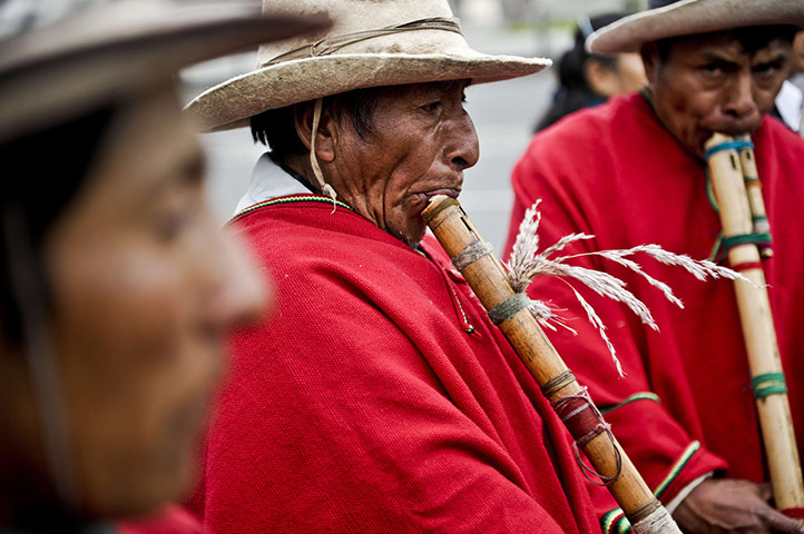 24 hours: Andean natives play reed flute during a parade