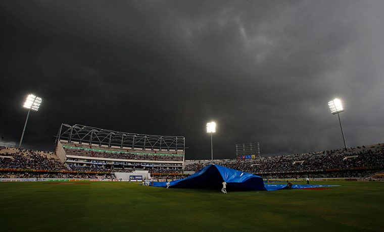 24 hours: Groundsmen pull covers over cricket ground