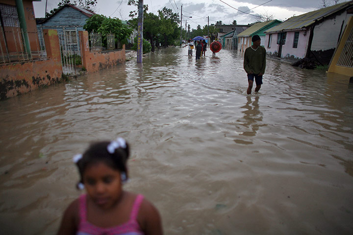 Tropical Storm Isaac: People wade through flooded streets after Tropical of Barahona