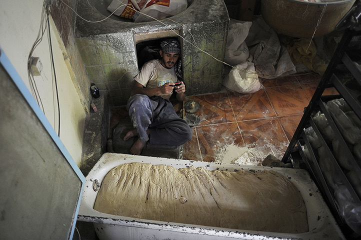 24 hours in pictures: An Afghan baker rests in his shop in Kabul