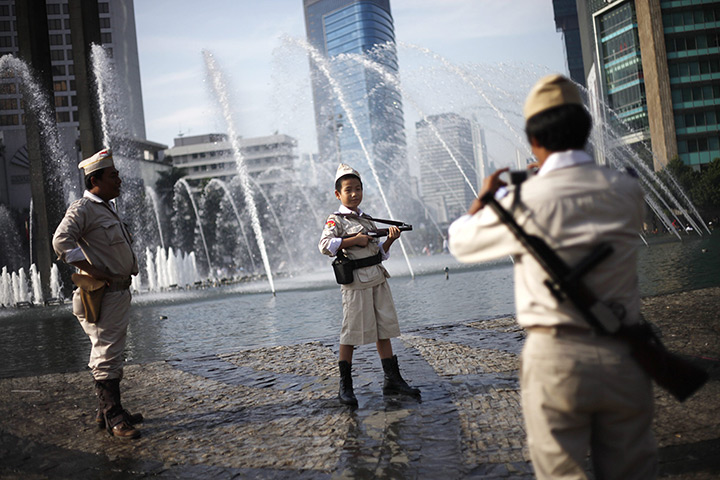 24 hours in pictures: A boy in Jakarta, Indonesia, poses for photos in the costume of an Indonesian independence hero