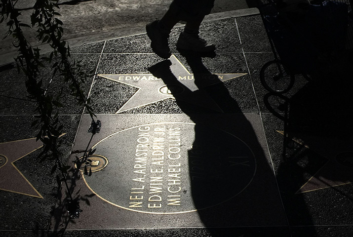 24 hours in pictures: A person walks past a plate on Hollywood Boulevard dedicated to astronauts Neil Armstrong, Edwin E Aldrin and Michael Collins
